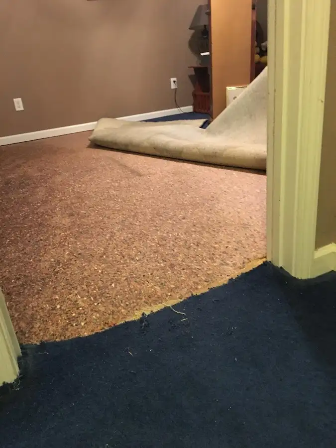Carpet pad removal revealing water damage during Water Mitigation Services in Kapolei
