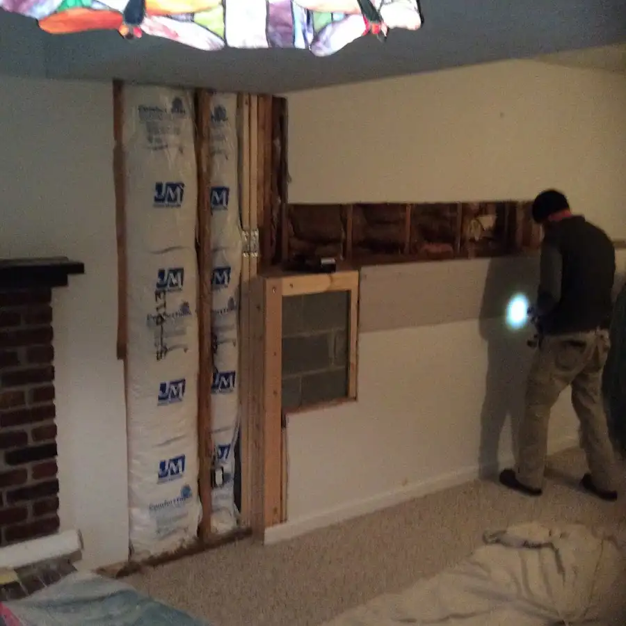 Restoration technician inspecting water damage in Kapolei